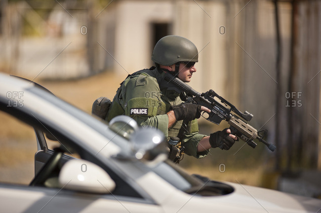 Military policeman holding a gun