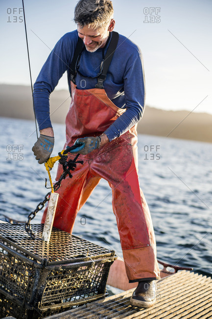 Man fishing using a lobster pot