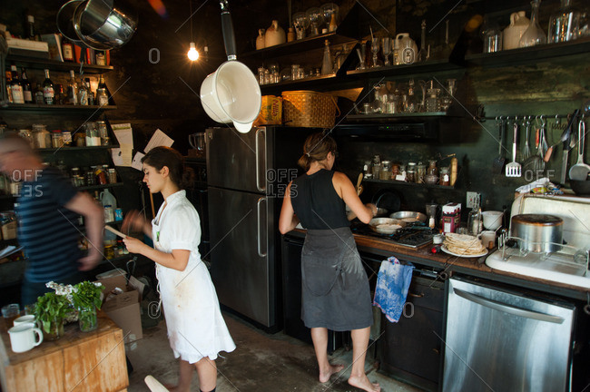 Beach Lake, Pennsylvania - August 4, 2012: People at work in rustic kitchen at the Mildred's Lane art complex