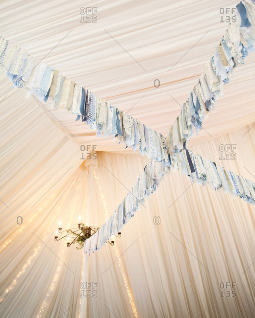 Blue Floral And Lacy Fabric Streamers Hanging From A Tent