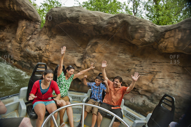 Family riding a water ride at an amusement park.