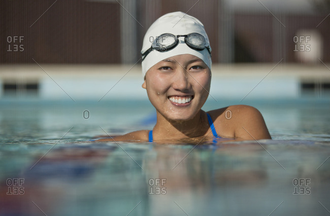Smiling young woman in a swimming pool.