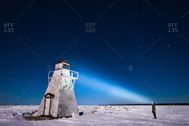 Nighttime over abandoned lighthouse in winter
