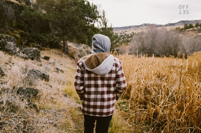 Man in flannel walking in mountains