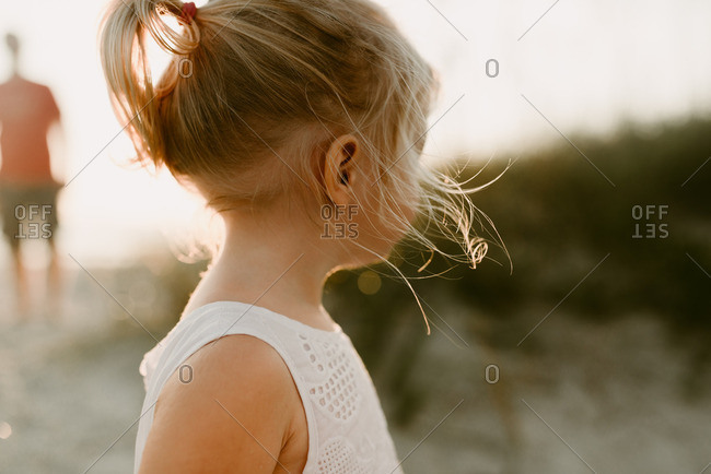 Close up of a little blonde girl looking away