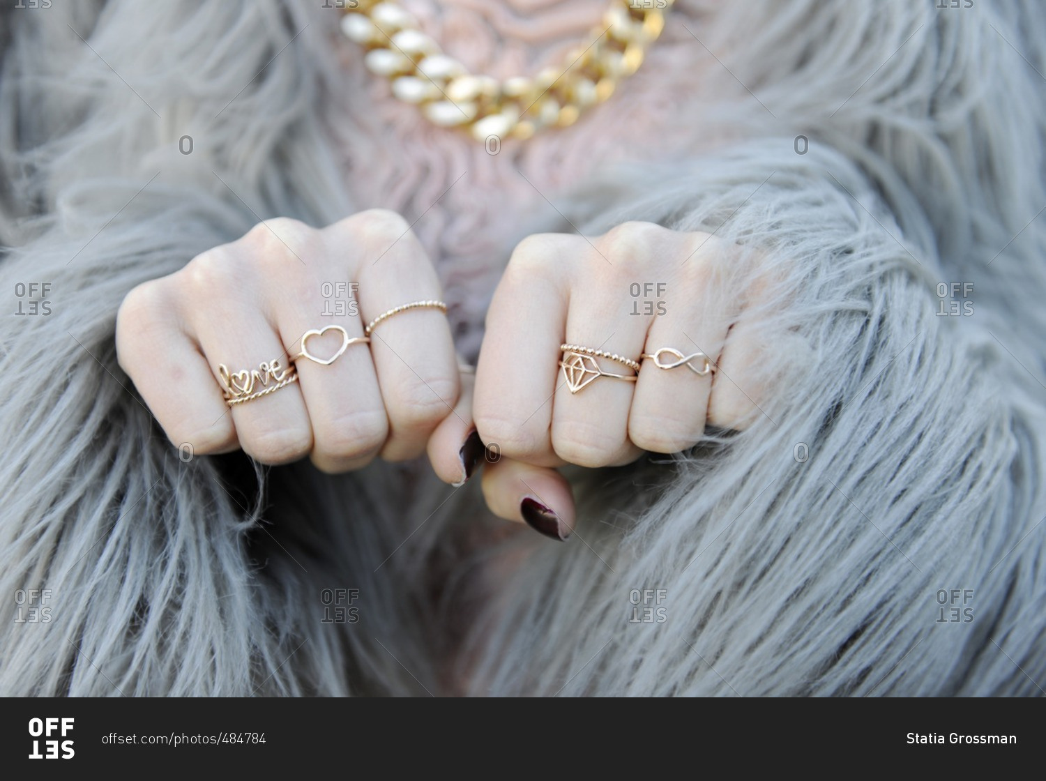 Woman in fur coat with lots of rings