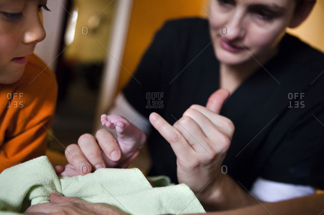 Midwife Performing Vitals Sign Checked On New Born Baby Girl