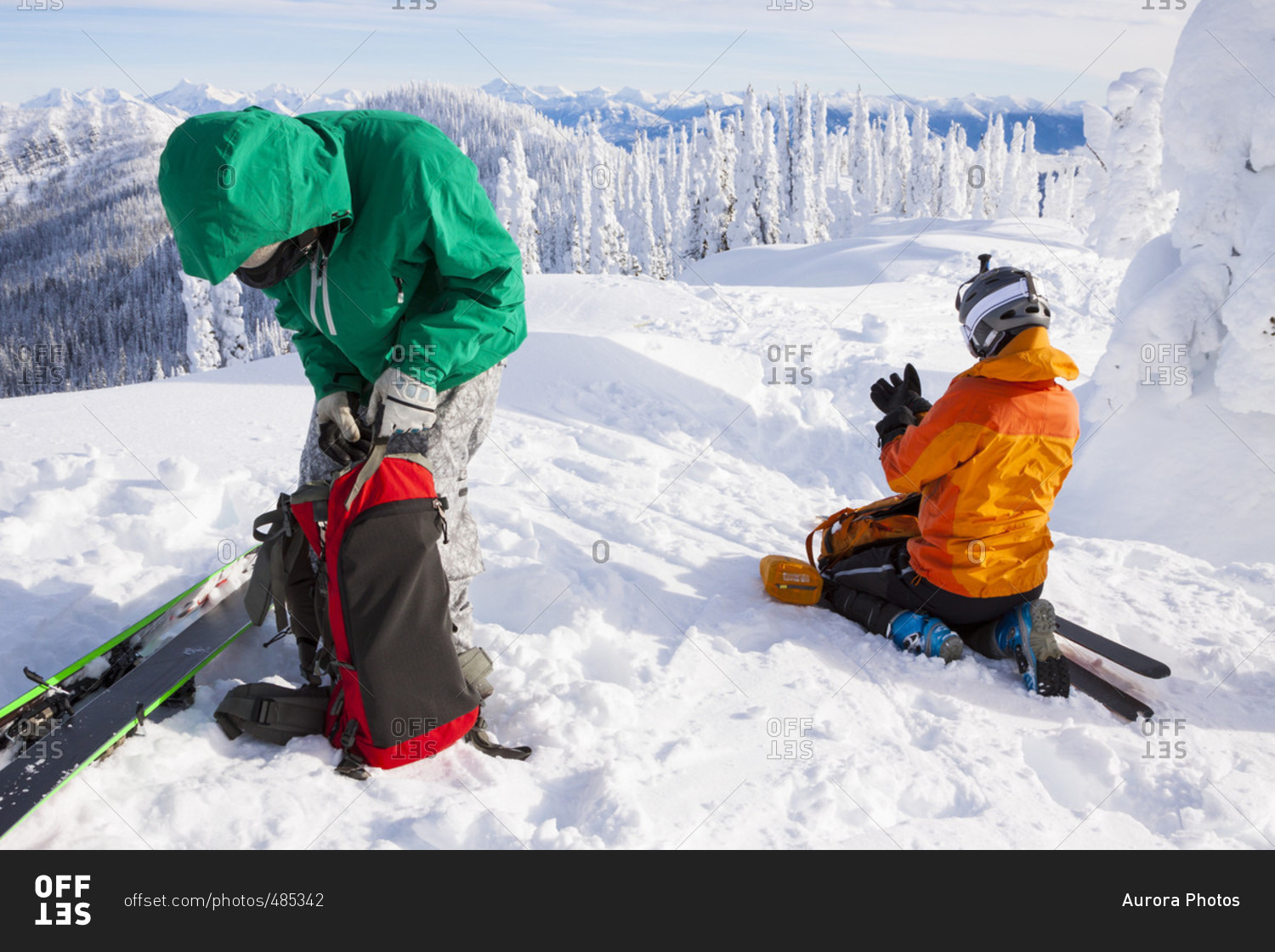 Male And Female Skier Packs Their Backpack After Skinning Near Whitefish, Montana, Usa