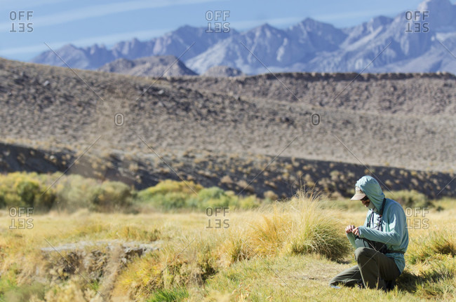 Fisherman Prepares His Fly Before Fly Fishing On The Owens River, Bishop, California