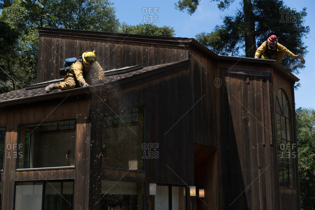 July 31, 2016 - Big Sur, California: Firefighters working to minimize risk to a house in the path of the Soberanes wildfire