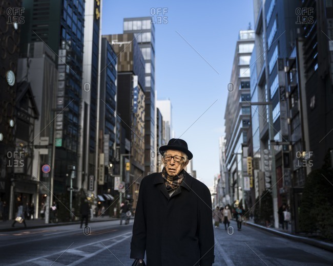 Tokyo, Japan - December 3, 2016: Senior businessman in Tokyo, Japan walking home after work