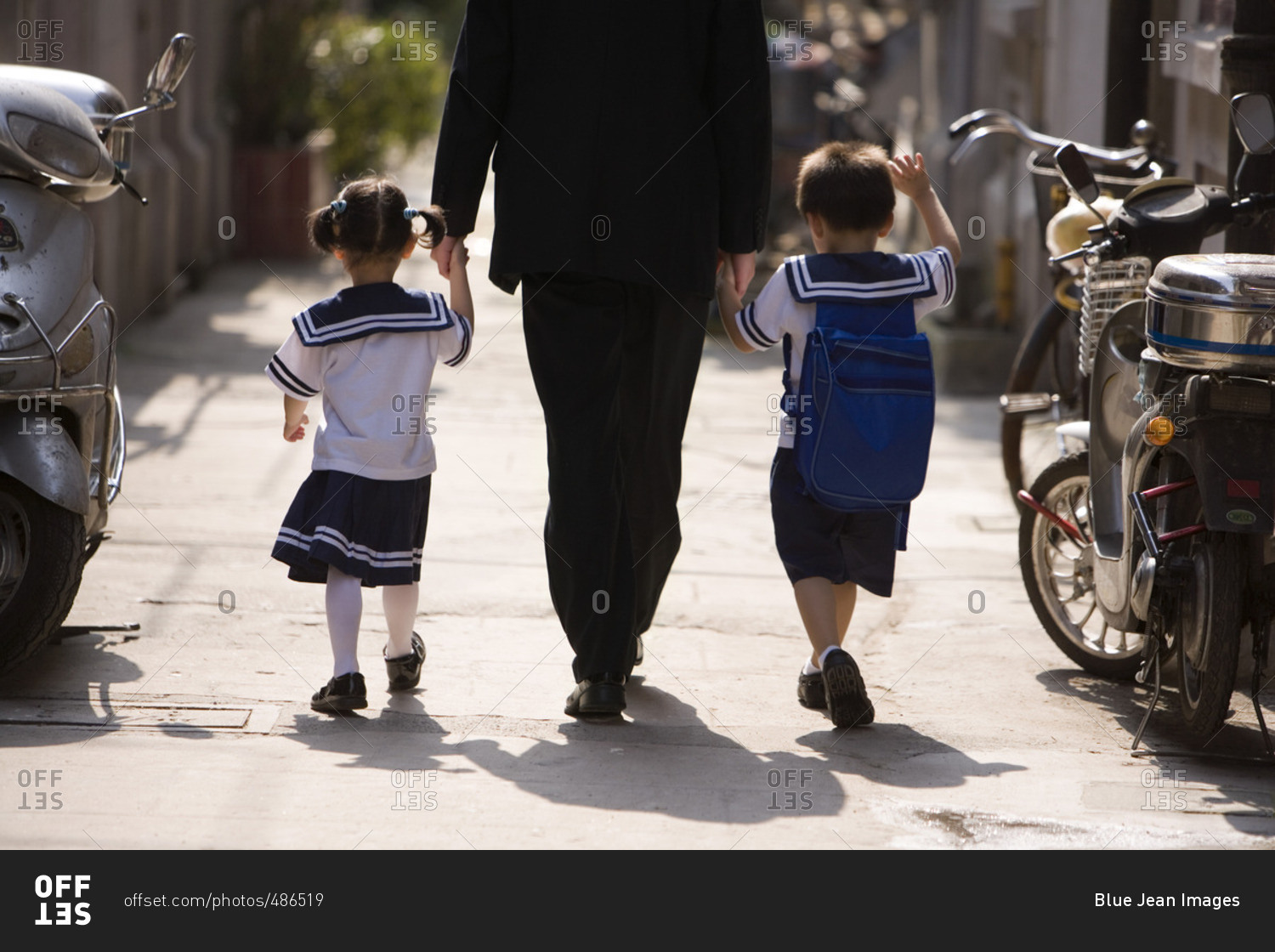 A father picks his children up from school