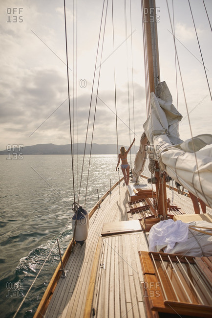 Beautiful Woman On Sailboat In Bikini Stock Photo Offset