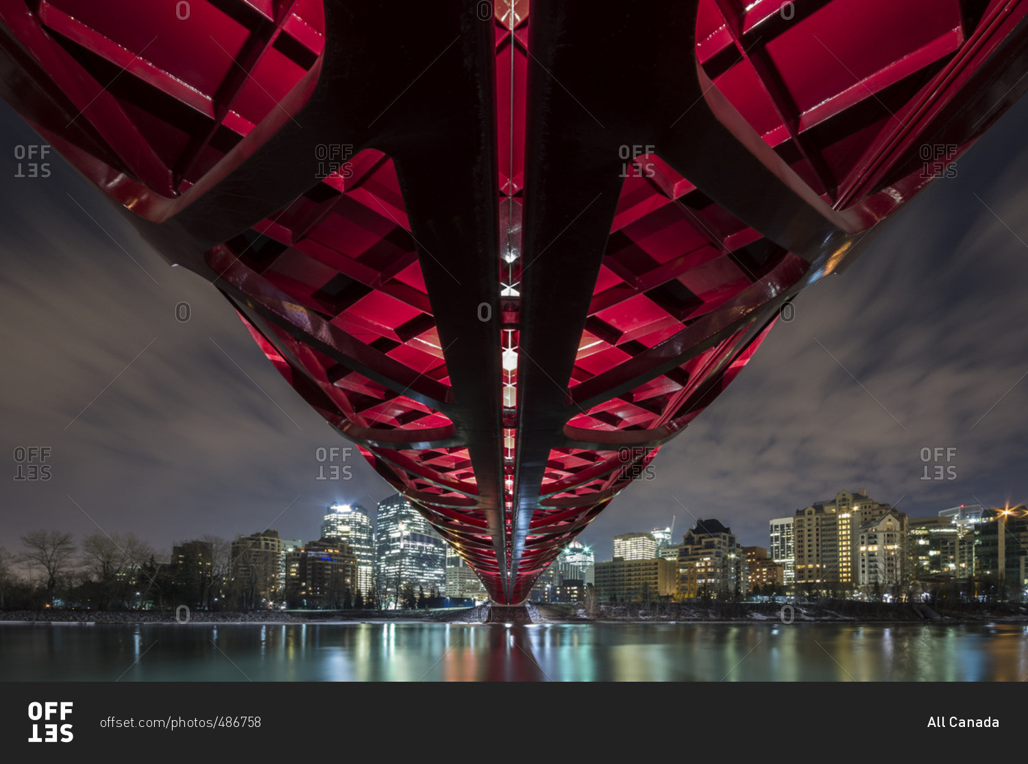 Pedestrian Peace Bridge And Downtown Calgary Reflecting In The Bow