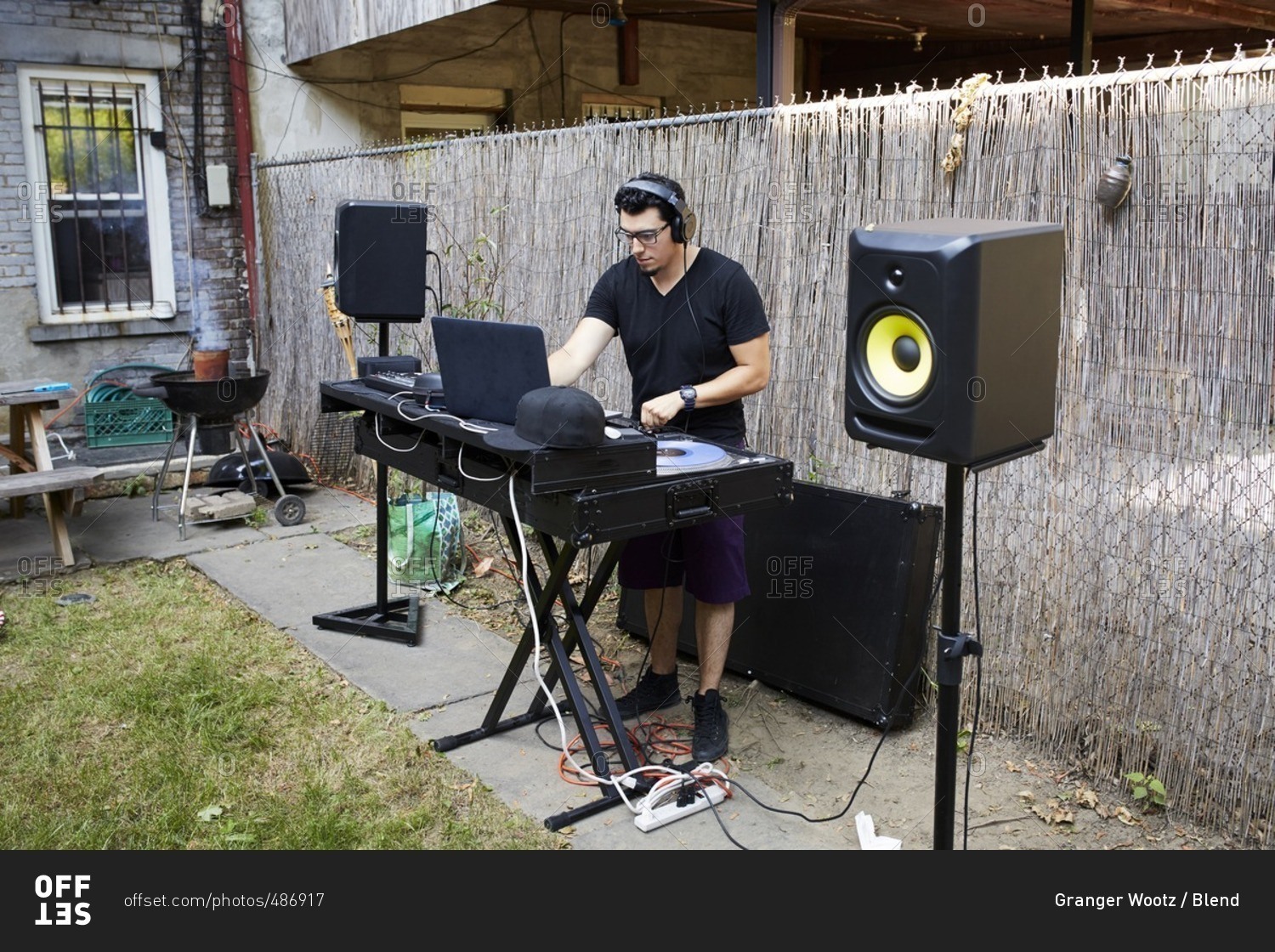 Hispanic do playing music in backyard