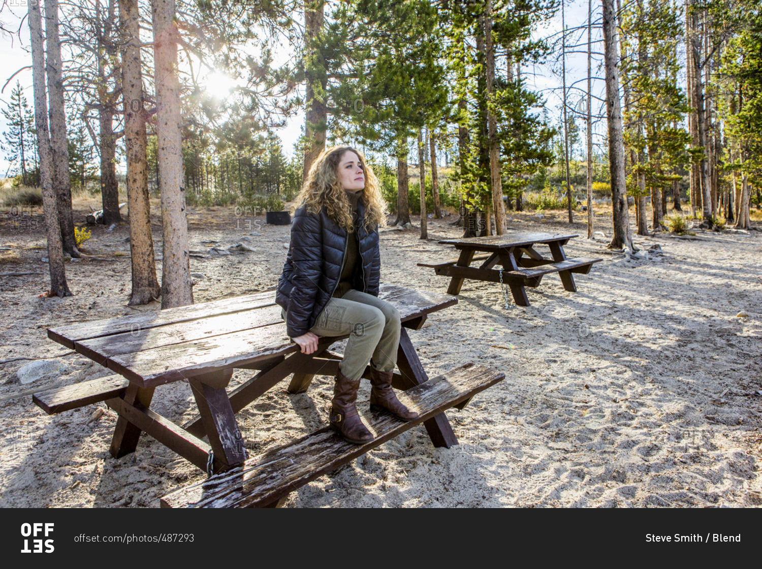 Caucasian woman sitting on picnic table