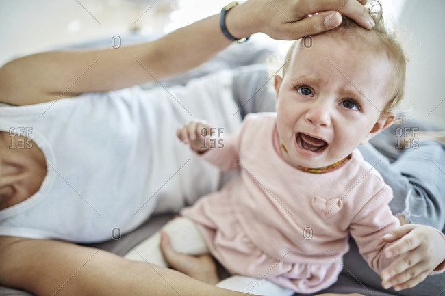 Mother Comforting Crying Baby Girl Stock Photo Offset
