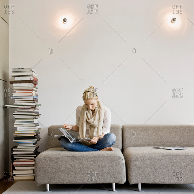 Woman reading a stack of books