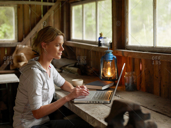 Woman with laptop and mug