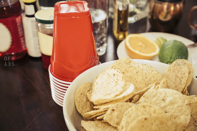Tortilla chips and ingredients for mixed drinks at a party