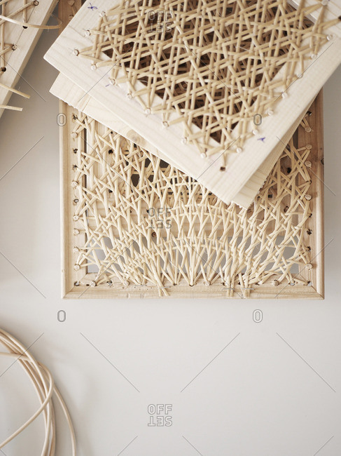 Close up of a woven rattan whicker on wooden frames