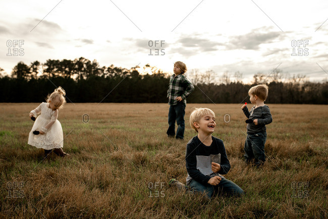Children playing together in a country field