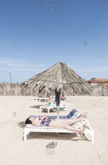 Boa Vista, Cape Verde - January 3, 2017: People relaxing in lounge chairs on the beach