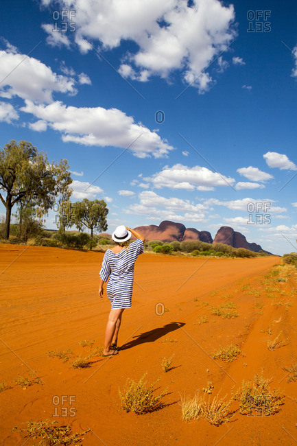 Woman walking in red desert landscape of Australian Outback