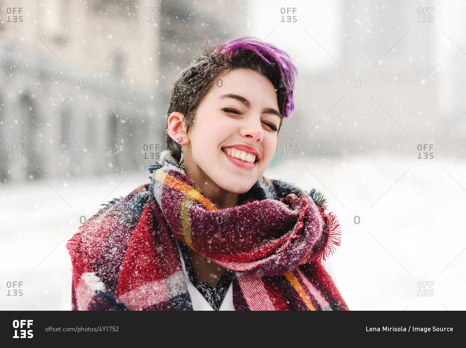 Portrait of young woman standing in front of the Christian Science Centre and Prudential building with snow, Boston, Massachusetts, USA