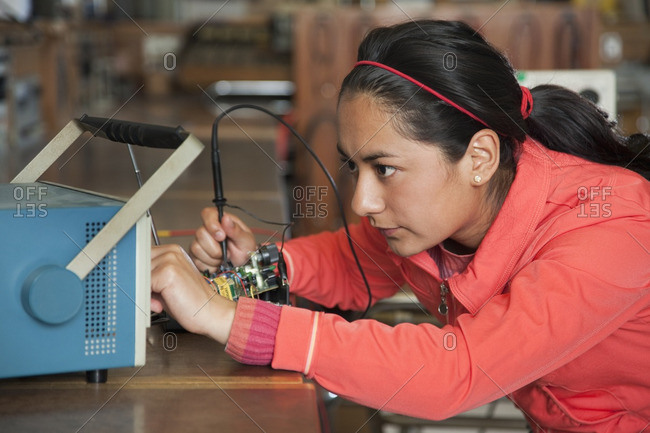 Hispanic woman working in electronics lab