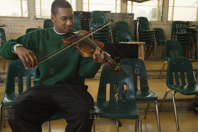 Black student practicing on violin