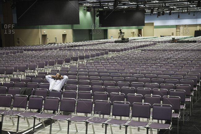 Black businessman waiting in empty conference center