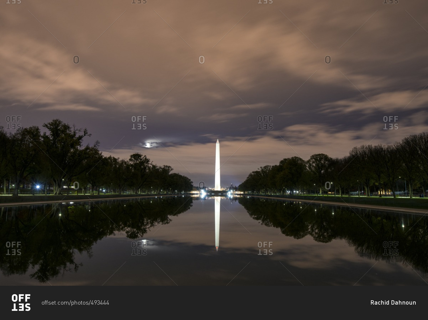 The Lincoln Memorial Reflecting Pool reflects the Washington Monument at night in the National Mall of Washington DC, USA.