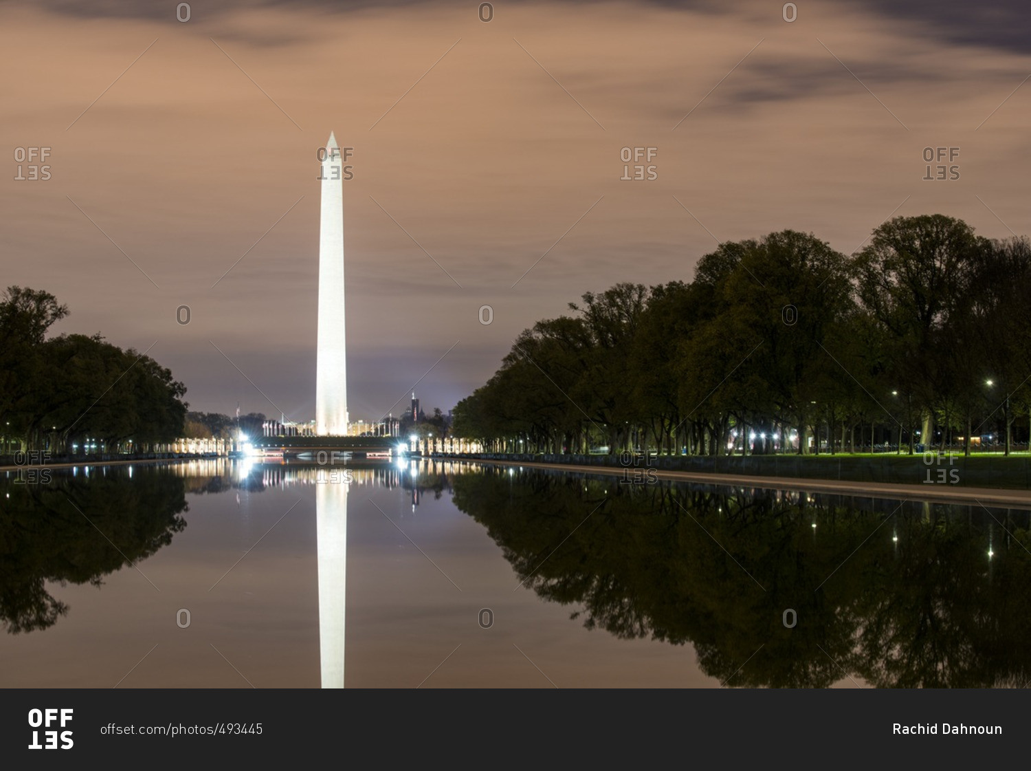 The Lincoln Memorial Reflecting Pool reflects the Washington Monument at night in the National Mall of Washington DC, USA.
