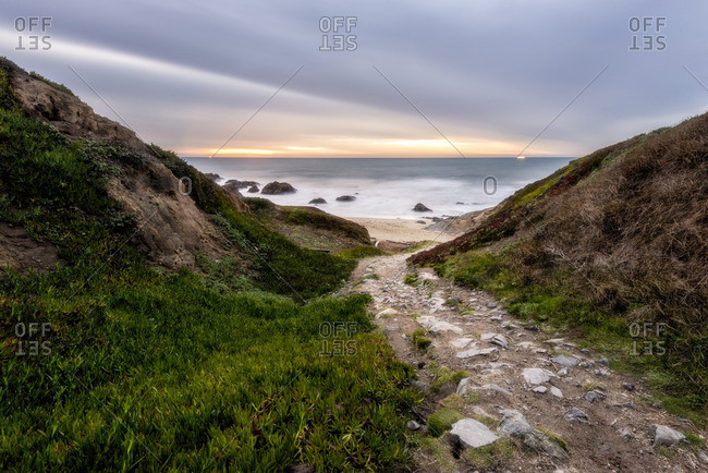 A rocky path leads down to the beach at Bodega Head near Bodega Bay at sunset, California.