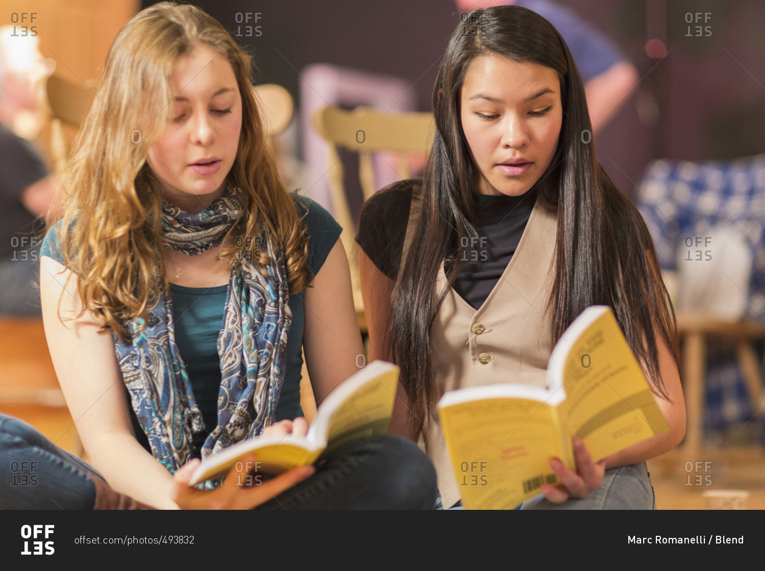 Teenage girls reading scripts in theater class