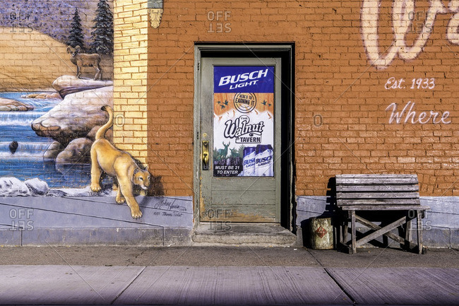 Yankton, South Dakota, USA - July 8, 2016: Exterior brick wall with mural and entrance to bar