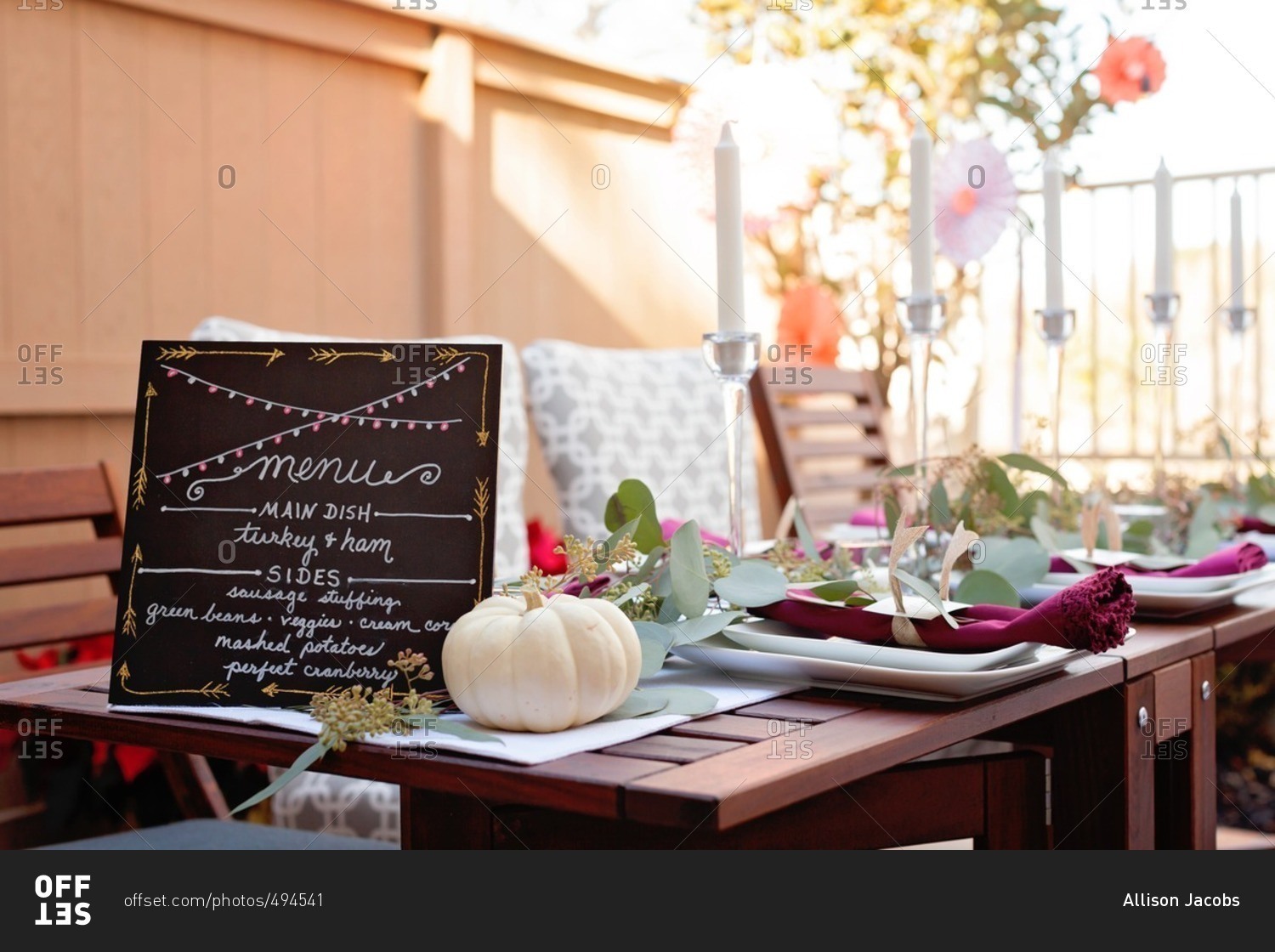 Table with menu at an outdoor Thanksgiving dinner party