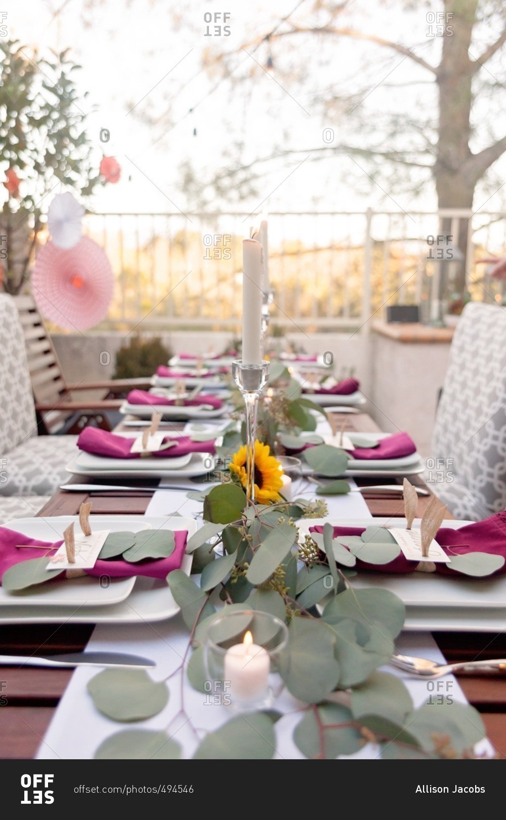 Table with candlelight set for an outdoor Thanksgiving dinner party