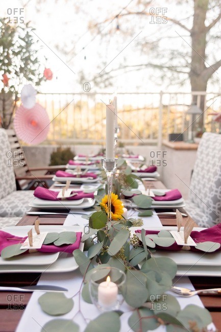 Table with candlelight set for an outdoor Thanksgiving dinner party