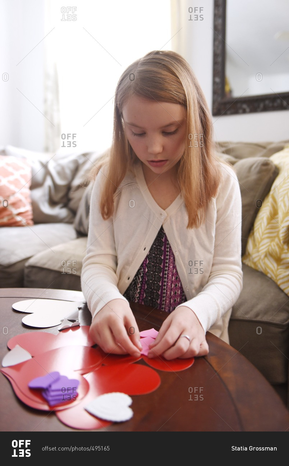 Girl making valentine's at table