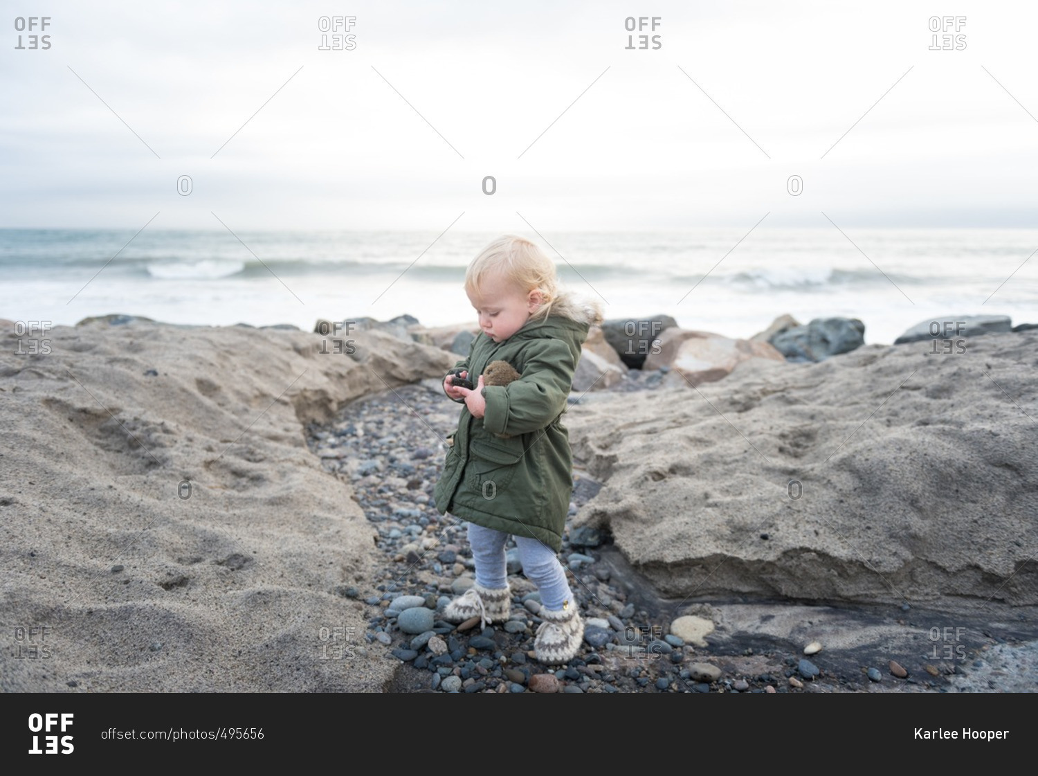 Child exploring on cold weather beach