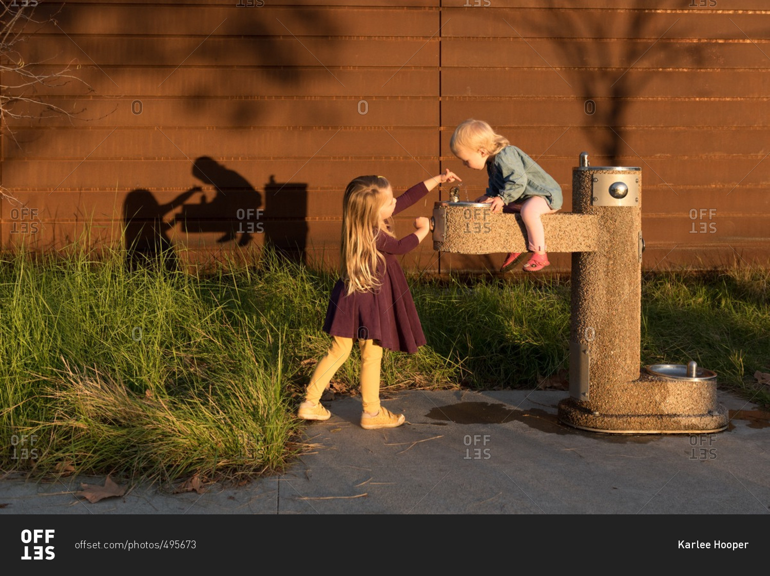 Girls playing around a water fountain