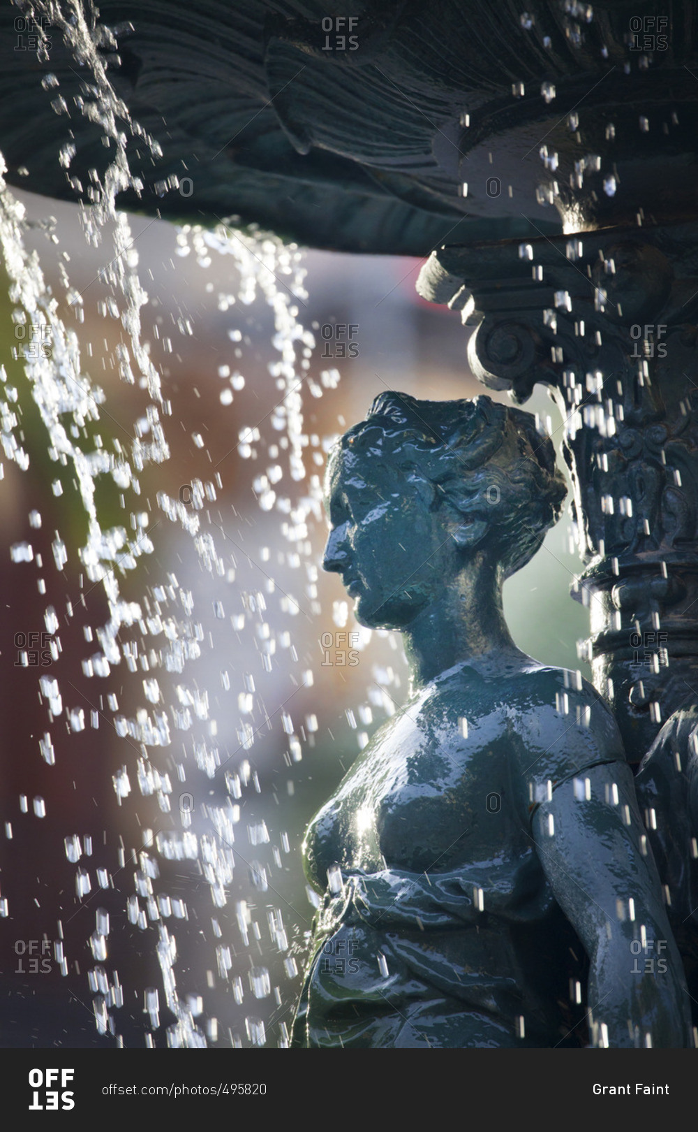 Water dripping on a carved woman in a fountain