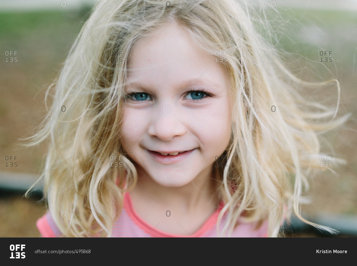 Close-up portrait of a beautiful young girl with messy blond hair
