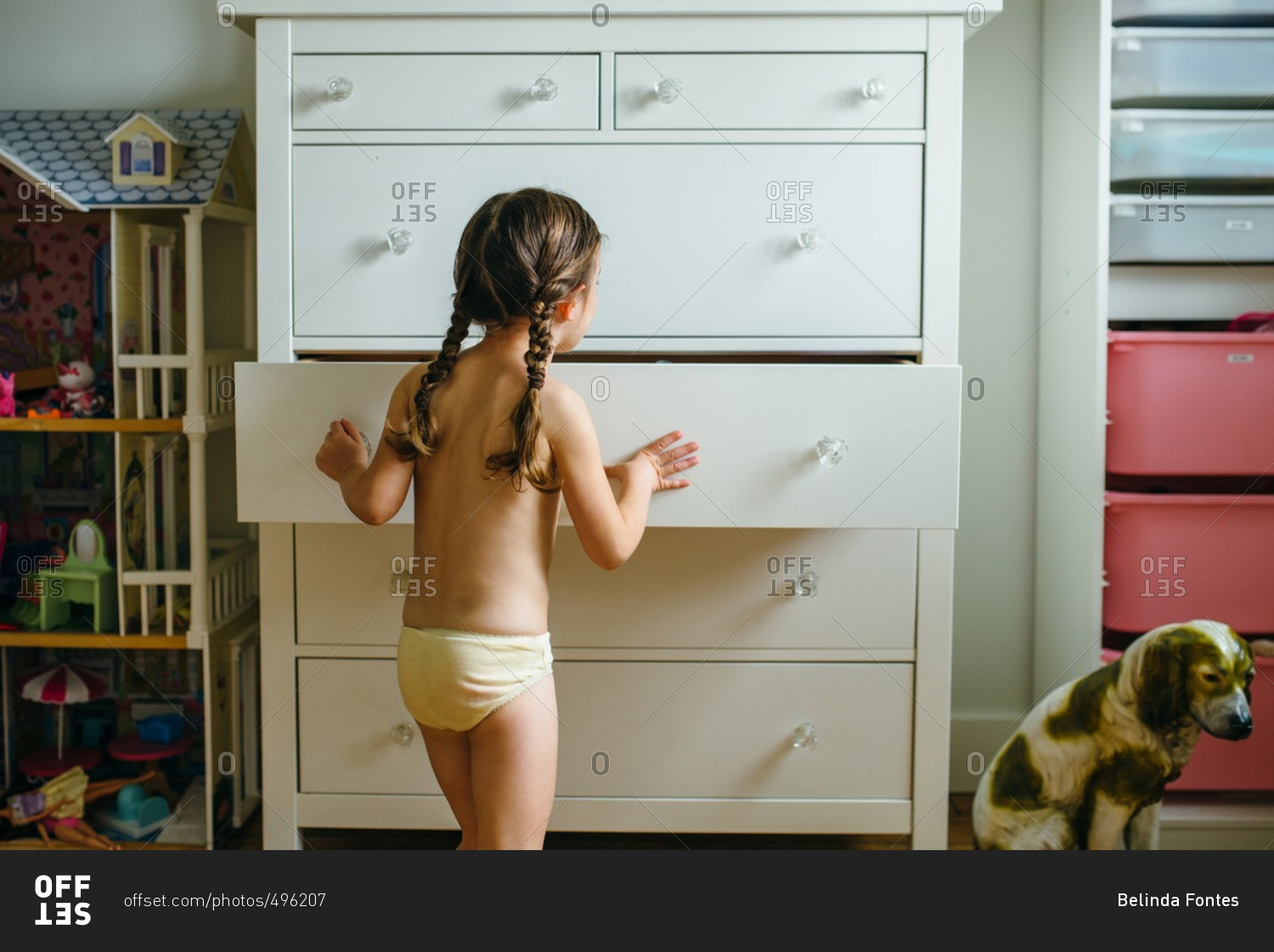 Little girl picking her clothes out