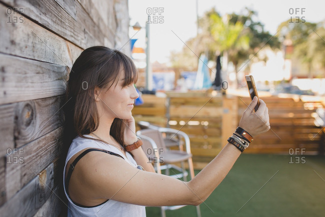 Young woman taking a selfie with smartphone