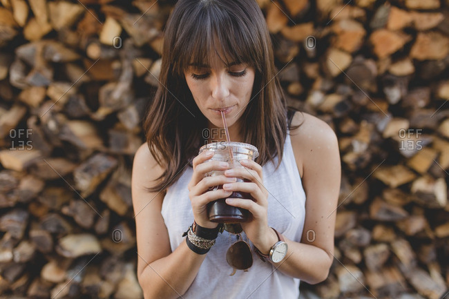 Casual Young Woman Drinking Iced Coffee Casual Young Woman Drinking Iced Coffee