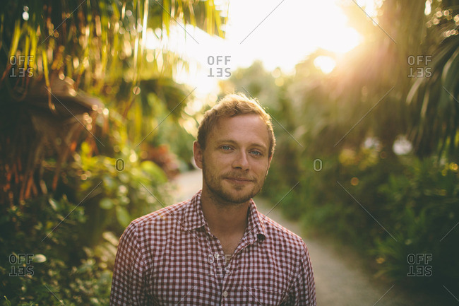 Portrait of man on path in tropical forest