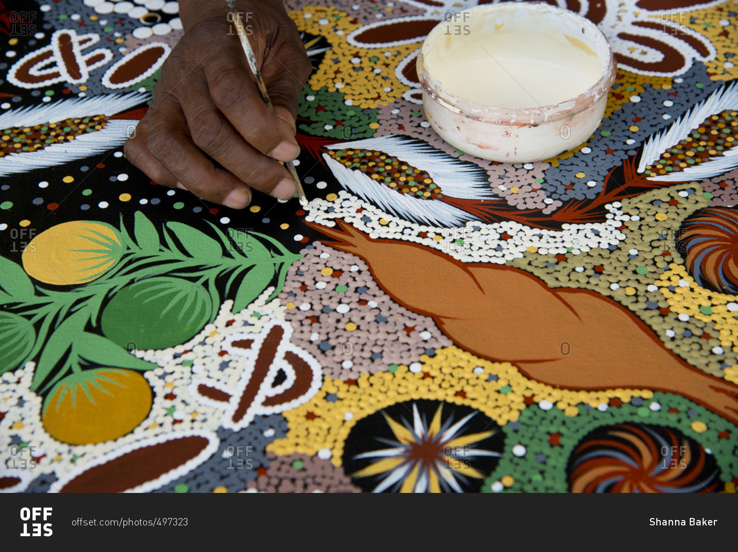 Detail of an artist painting in a traditional aboriginal style, in Darwin, Australia